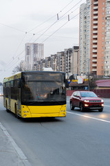 Naklejka na ściany i meble yellow public bus on the road