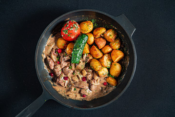 roasted potatoes with meat and vegetables