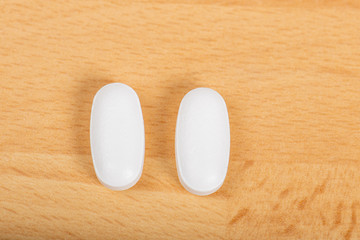 Medicine : tablets on a wooden background