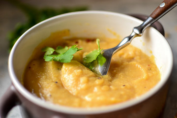 Pea cream soup in a bowl on a wooden background. Pea puree and porridge. Close up.
