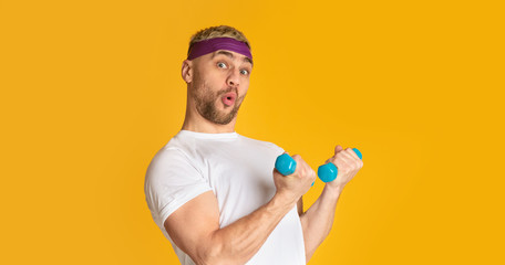 Man blowing lips and funny engaged with small dumbbells