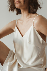 Closeup of young beautiful woman in silk underwear. Fashion concept.