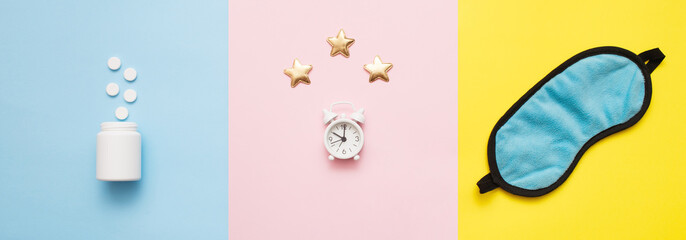 Pills, bottle, sleeping mask and white alarm clock with stars on pink, yellow, blue art background. Concept Insomnia, sleep problems, time to take pills and treatment. Top view, flat lay, copy space