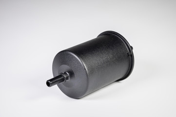 New fuel filter in a black plastic housing for diesel and gasoline engines on a gray background