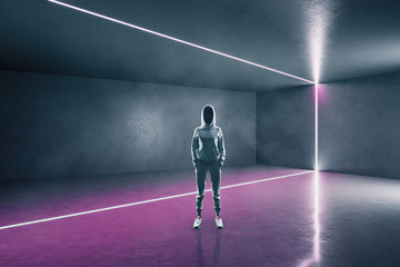 Hacker standing in futuristic gallery interior