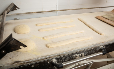 Proofing bread and baguettes in baker workshop