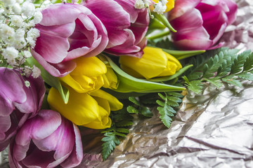 pink and yellow tulips bouquet on paper background
