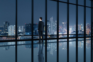 Fototapeta na wymiar Businessman standing in contemporary office interior