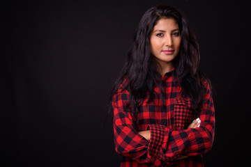 Portrait of young beautiful Indian hipster woman with arms crossed