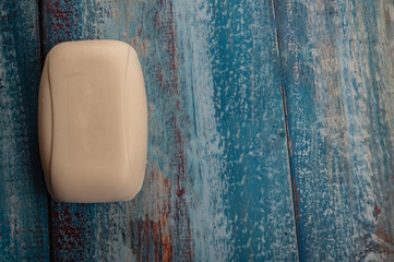 A piece of toilet soap on a wooden background. Close up. Hand washing is the prevention of COVID-19...