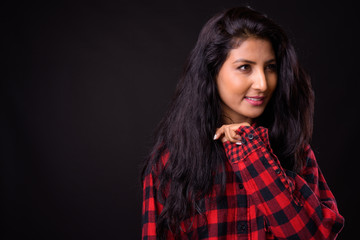 Face of happy young beautiful Indian hipster woman thinking