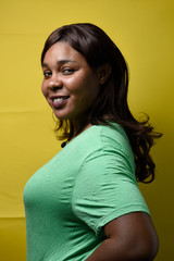 Portrait of happy black girl isolated on yellow background