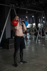a young athletic guy trains with weights