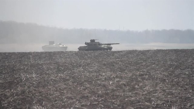 Tank exercises at the training ground. Shots of tanks in motion.