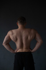 Fototapeta premium athletic guy strains his back