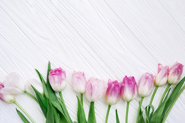 Frame from Pink Tulips Flowers on white table for March 8, Women's Day, Birthday, Valentine's Day or Mother's day - Closeup