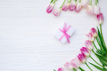 Frame from Pink Tulips Flowers with gift on white table for March 8, Women's Day, Birthday, Valentine's Day or Mother's day - Closeup