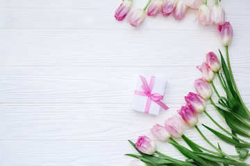 Frame from Pink Tulips Flowers with gift on white table for March 8, Women's Day, Birthday, Valentine's Day or Mother's day - Closeup