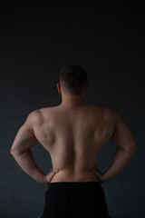 Fototapeta premium athletic guy strains his back