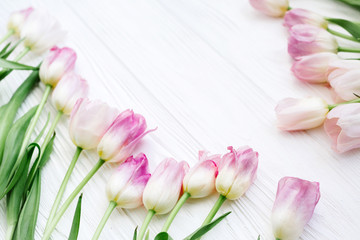 Frame from Pink Tulips Flowers on white table for March 8, Women's Day, Birthday, Valentine's Day or Mother's day - Closeup