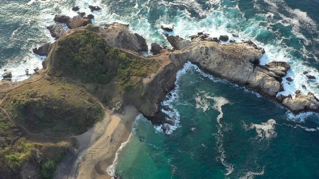 Aerial drone view. of Punta Cometa coastline and Mazunte beach in Oaxaca Mexico  Tilt 4K