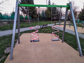 Closed children's playground. Ban on children 's playgrounds. Prevention of coronavirus COVID-19. The fight against the virus. No children on the Playground in the yard.