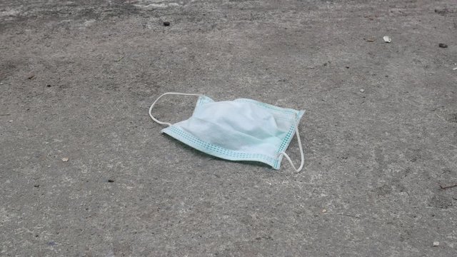 used mask on the floor concept corona virus,covid-19