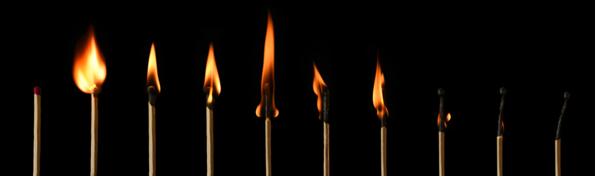 The stages of match burning on a black background. Safe match with red head. Different stages of matchstick burning. From Ignition to decay. Copy space, banner. 