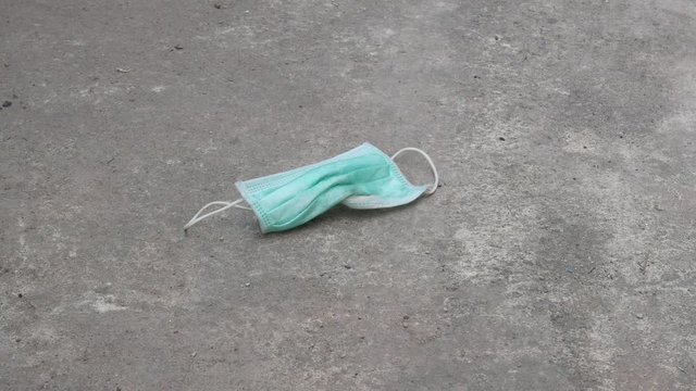 used mask on the floor concept corona virus,covid-19