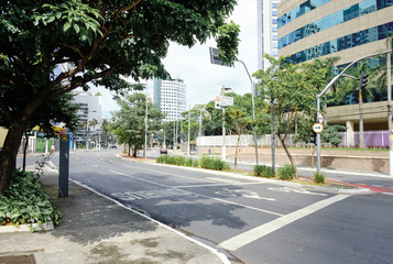 Empty Vila Olimpia, during coronavirus outbreak, Sao Paulo, Brazil with some cyclists - March 2020