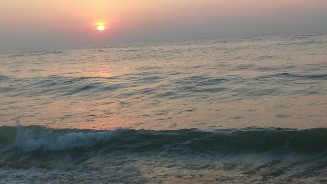 4K Sunrise over tropical island beach and palm trees. Phuket beach sea, View of beach sea on sun light in the summer. Colorful sunset over the beach in the tropical beach sea,the tropical paradise bea