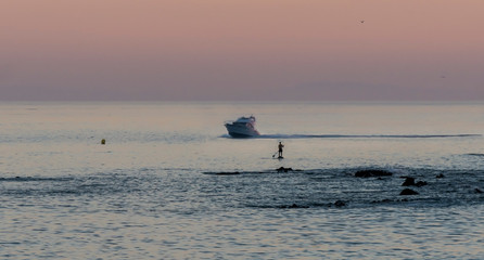 Fototapeta premium man practices the sport of paddle surf in the mediterranean