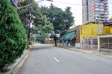 Empty street in Vila Olimpia, during coronavirus outbreak, Sao Paulo, Brazil with some cyclists - March 2020