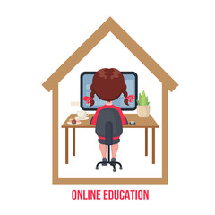 Young girl sitting at a table and studying at the computer at home .