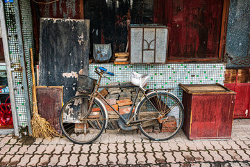 An old bicycle, broom, and still life set up in Jinxi, China