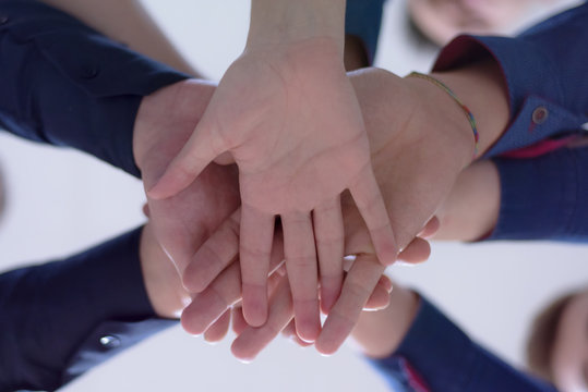 Young Business People Teamwork Stacking Hand Concept. Close Up Of Young  Business People Putting Their Hands Together. Friendly Business People  With Stack Of Hands Showing Unity And Teamwork.