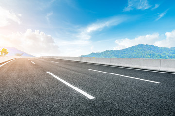 Empty asphalt road and green tea plantation nature landscape.