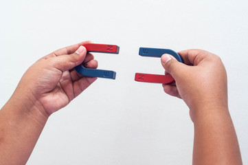 hand holding a magnet isolated on white background