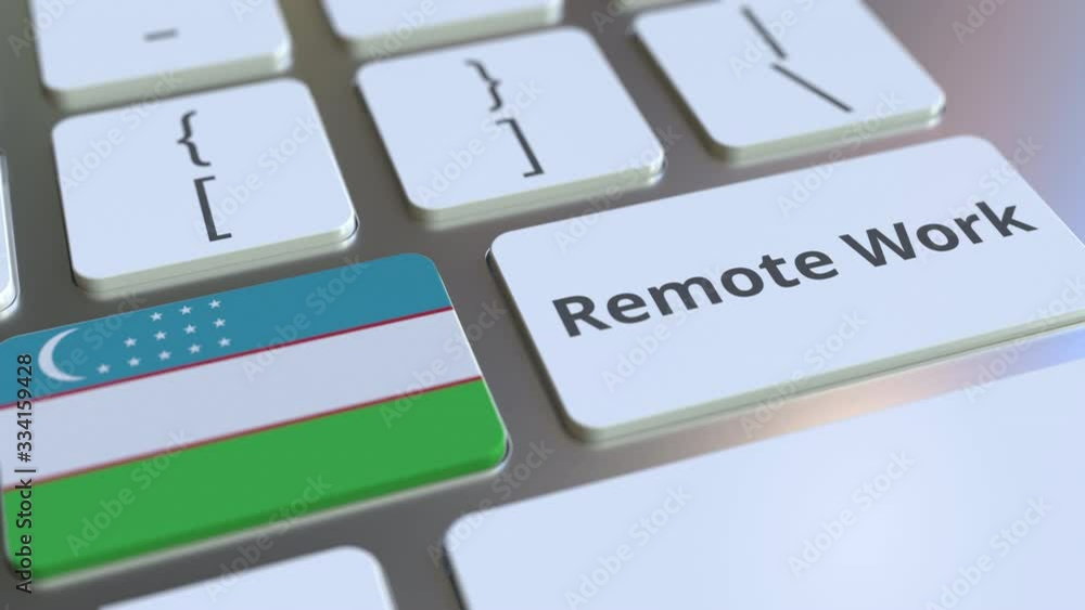 Poster remote work text and flag of uzbekistan on the computer keyboard. telecommuting or telework related 