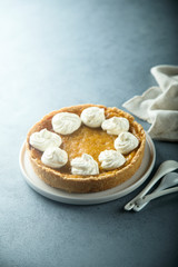 Fototapeta na wymiar Homemade pumpkin pie with whipped cream