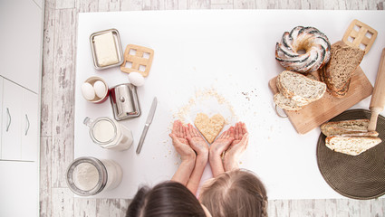The view from the top. Mom and daughter prepare pastries in the kitchen.