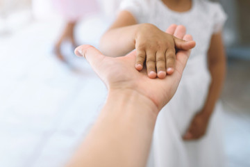 man holding girl's hand