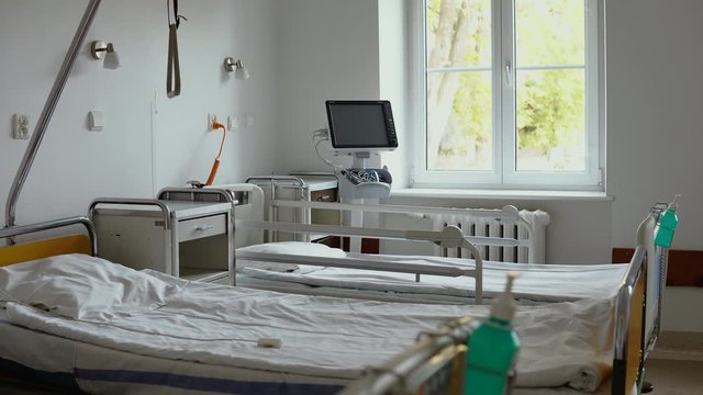 Hand video from empty hospital room, empty beds in room, 
no patients in the hospital room