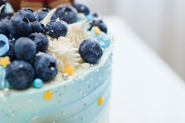 Cake in blue with blueberries and blue bow