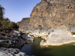 Fototapeta na wymiar Water in small reservoirs is retained in mountain streams. Oman