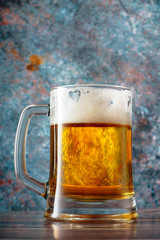 Glass of beer with foam on rustik background	