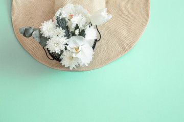 Summer background with flowers and a hat.