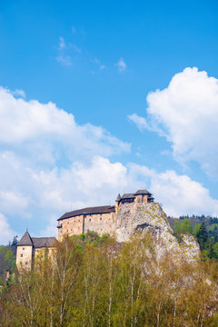 orava castle of slovakia. medieval fortress on a hill in a beautiful place in mountains. wonderful sunny weather with fluffy clouds in springtime