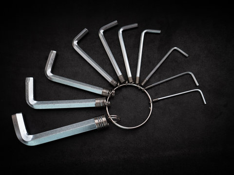 L-shaped hexagon wrench set on dark background.