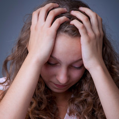Fototapeta premium Frustrated and depressed young woman. Sad tired female person experiencing burnout, pain and loss